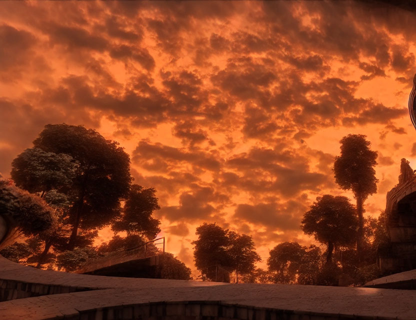 Dramatic red sky over deserted landscape with trees and steps