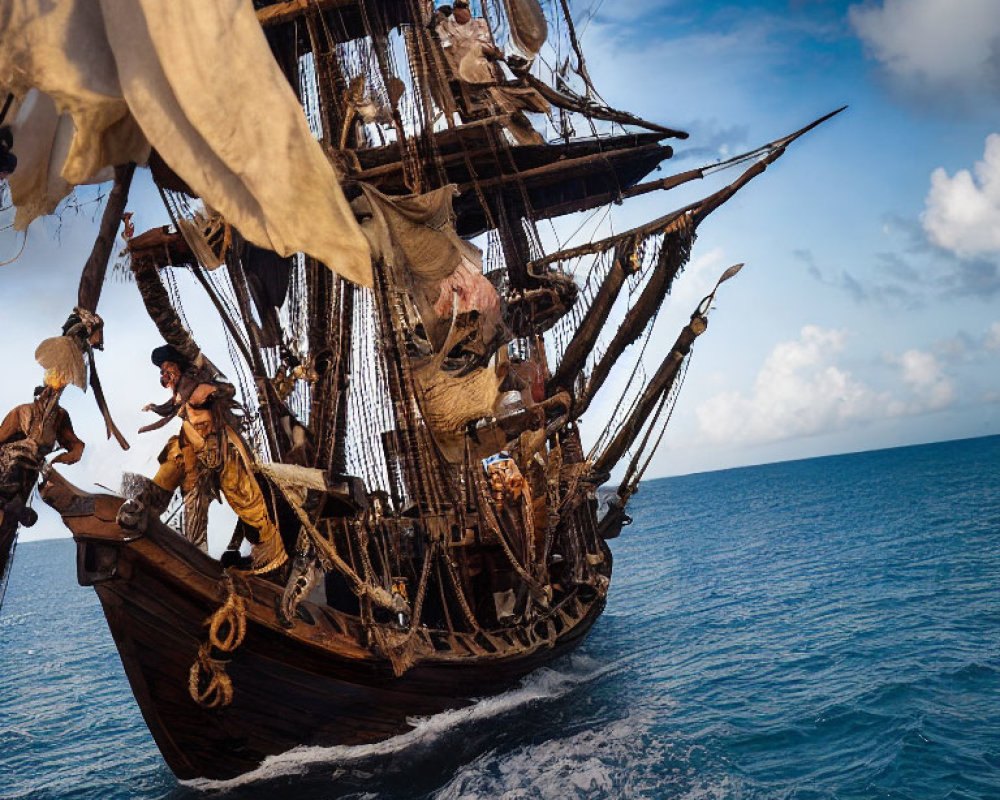 Wooden pirate ship sailing on the ocean with crew members on deck and in rigging