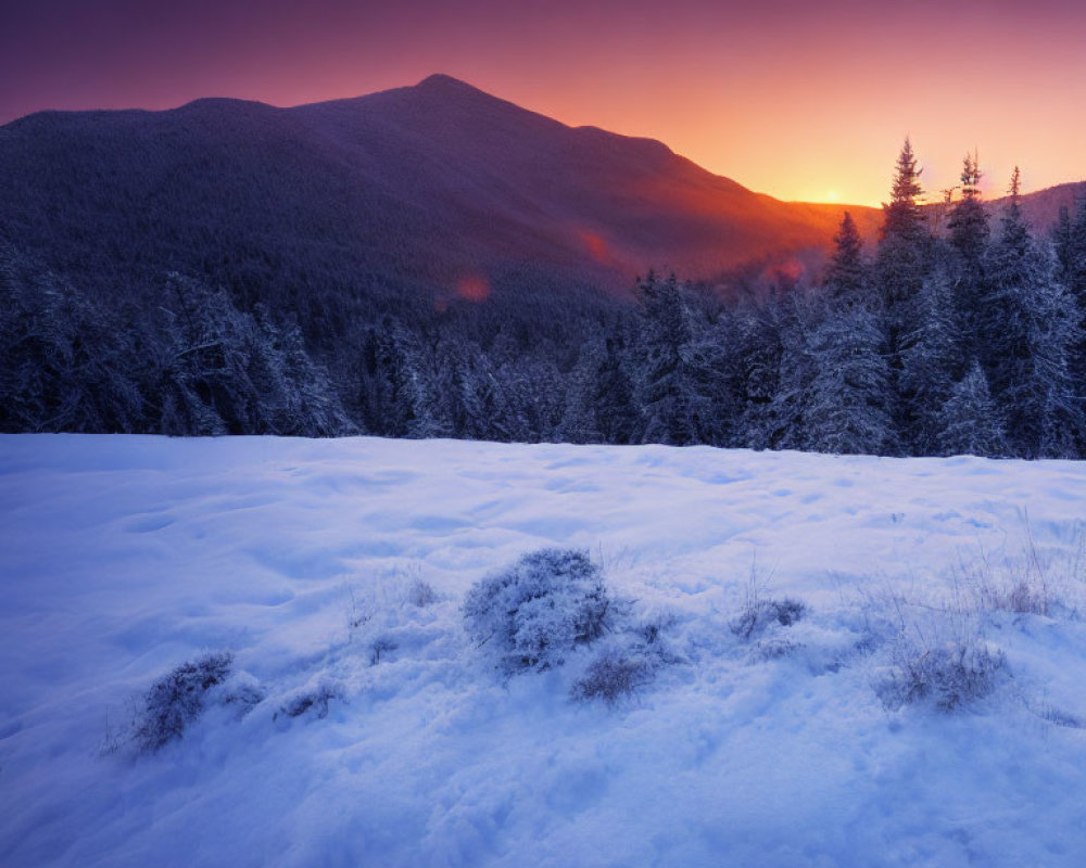 Snowy Dusk Landscape with Purple and Orange Skies over Mountain Silhouettes