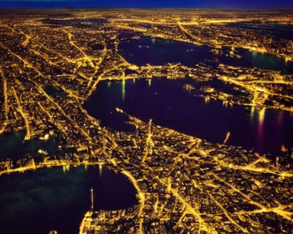 Cityscape with illuminated streets and aurora borealis over water