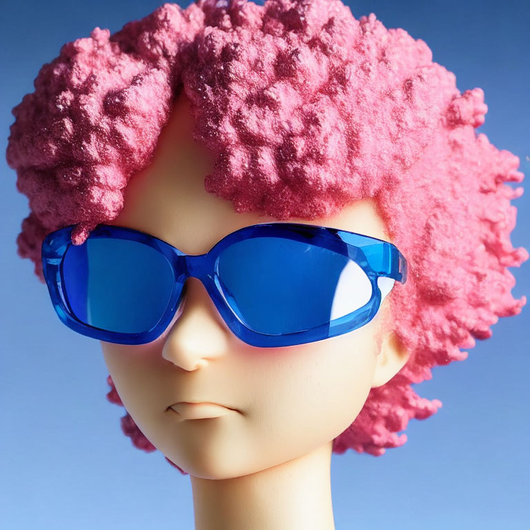 Mannequin head with pink coral hair and blue sunglasses on blue background