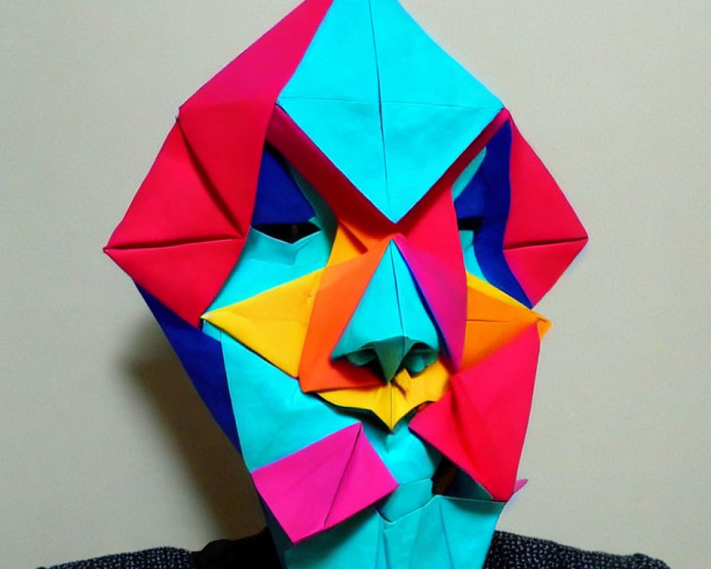 Colorful Geometric Origami Mask in Blues, Pinks, and Yellow on Neutral Background