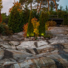 Giant duck-like hill dominates surreal landscape with human figures and whimsical trees.