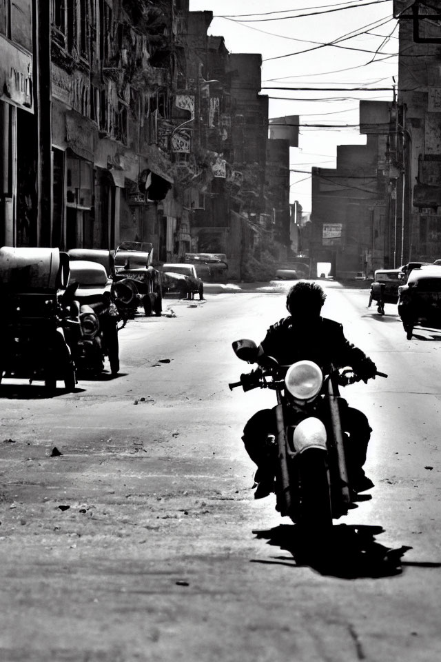 Monochrome urban street scene with person on motorcycle