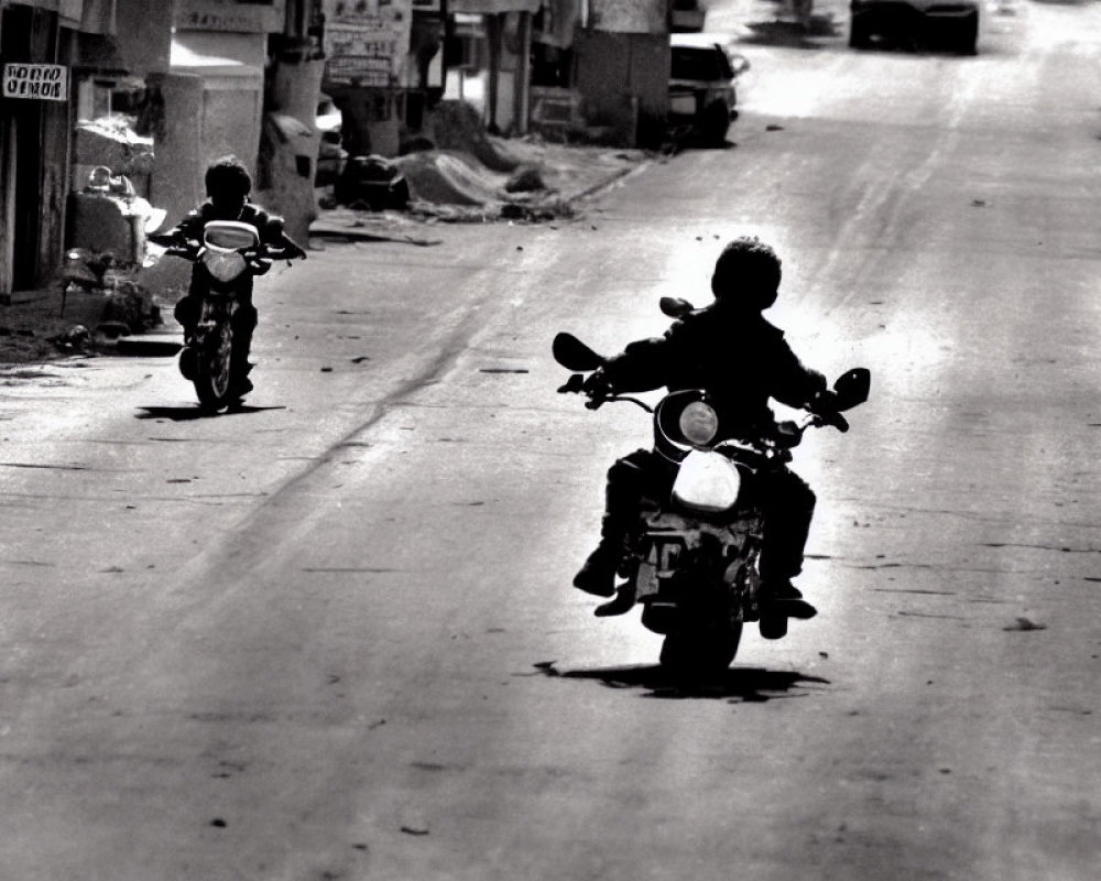 Children riding motorbikes on deserted street with buildings and debris in black and white.