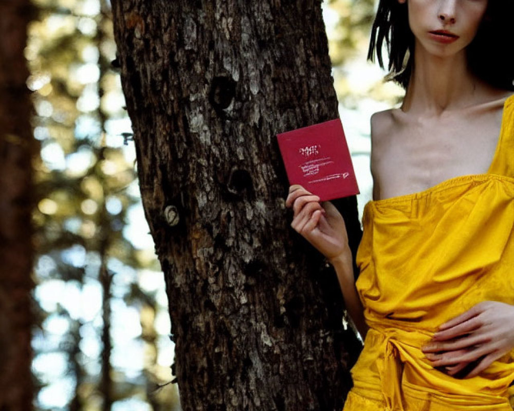 Woman in Yellow Dress Holding Red Book in Forest