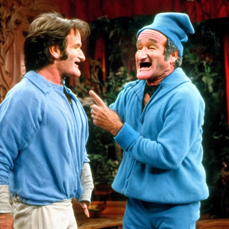 Two men in blue shirts laughing, one wearing a woolen hat