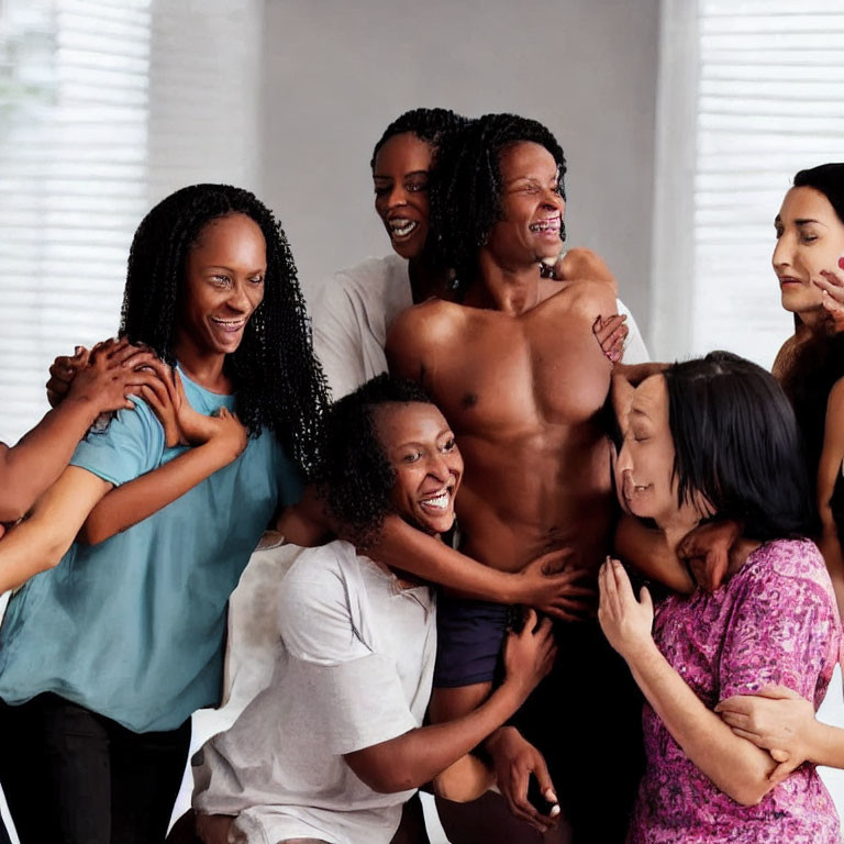 Diverse group of people embracing and laughing together