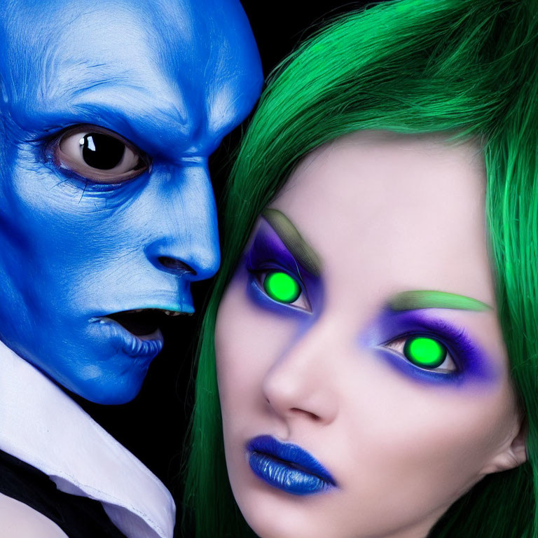 Two individuals with blue and green fantasy makeup and intense stares.