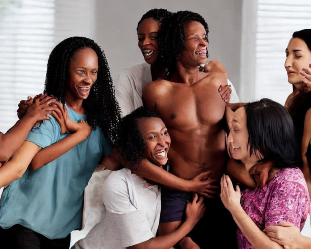 Diverse group of people embracing and laughing together