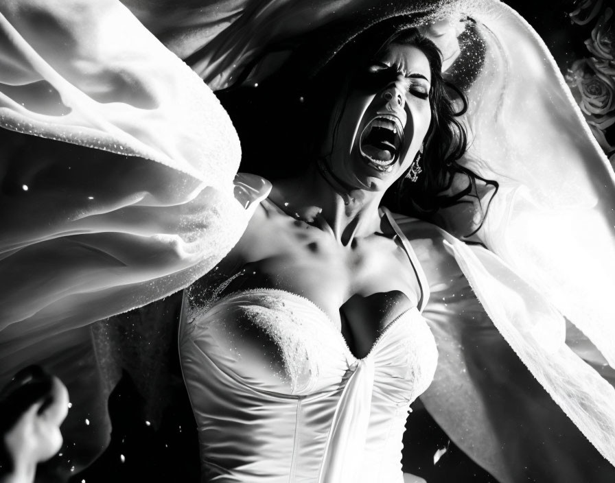 Monochrome photo of woman in wedding dress screaming