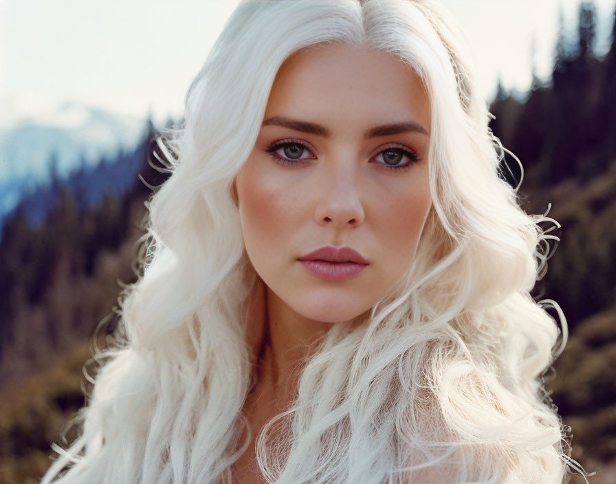 Portrait of Woman with Long White Hair and Blue Eyes in Mountainous Setting