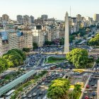 Colorful cityscape with lush green trees and clear blue sky