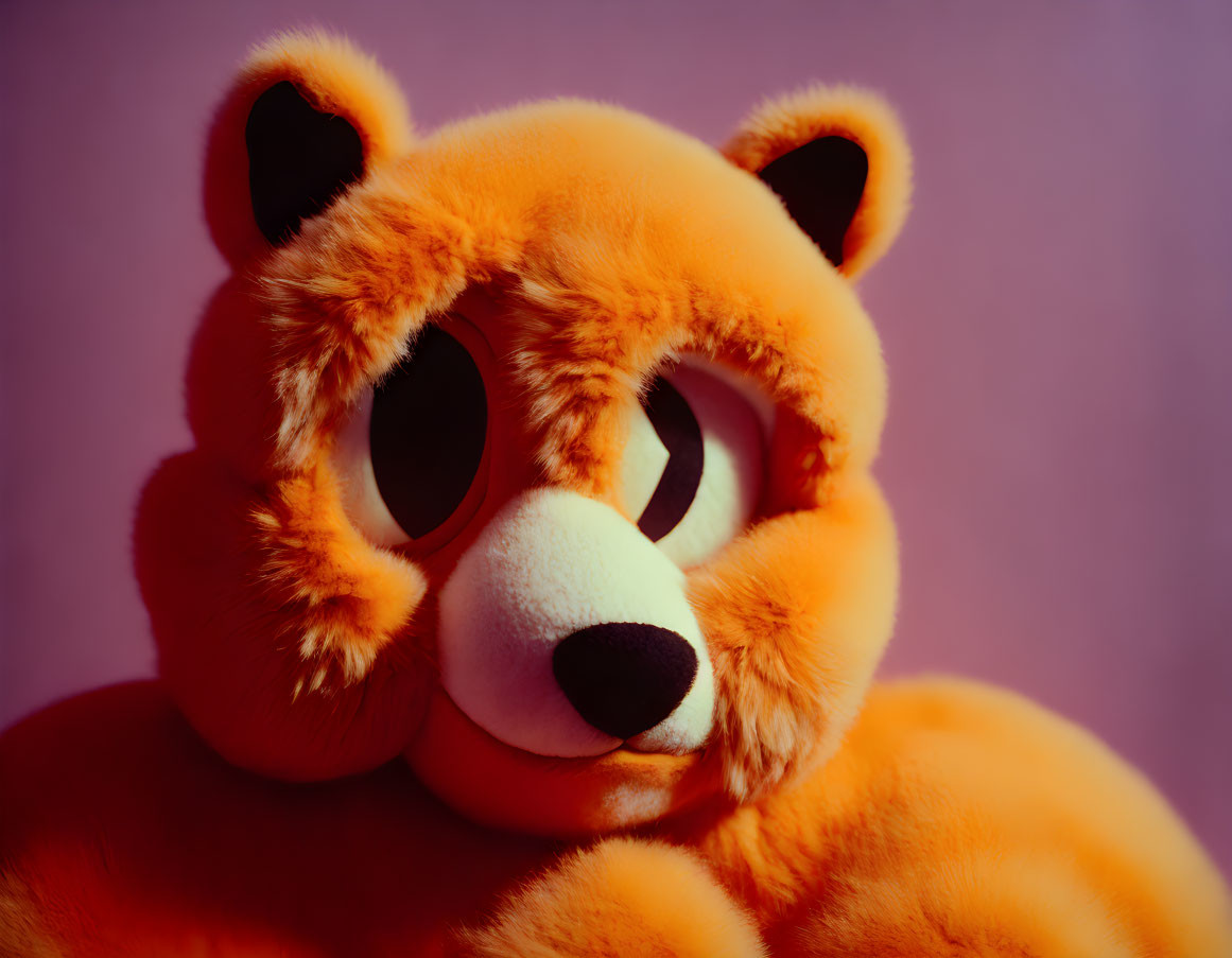 Orange Plush Toy with Sad Expression on Purple Background