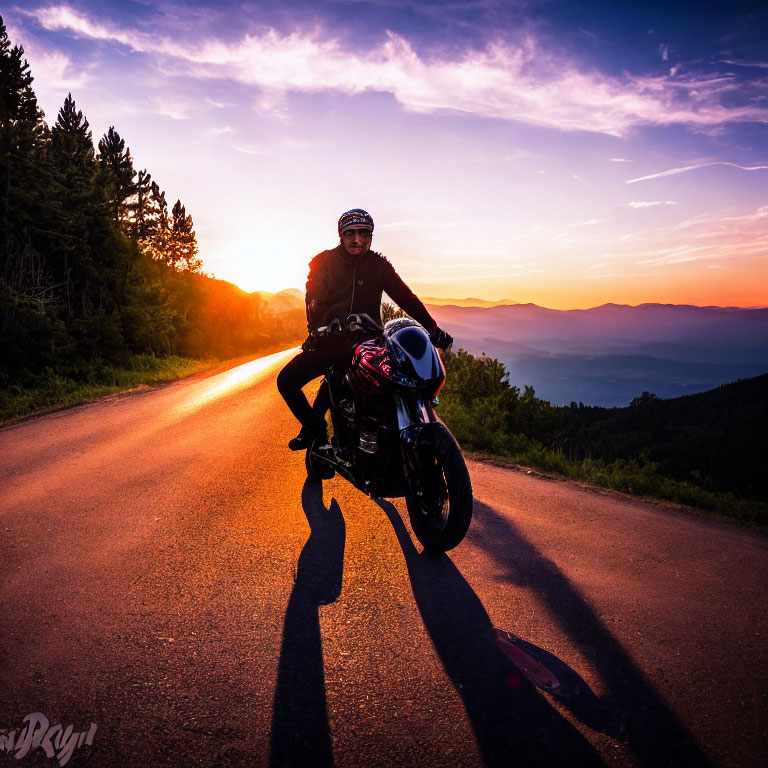 Motorcyclist on Mountain Road at Sunset with Vibrant Sky Colors