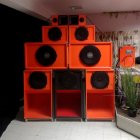 Luxurious High-End Audio System with Large Orange Speakers, Digital Receiver, Decorative Plant, and