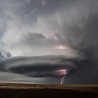 Layered Supercell Thunderstorm with Purple Lightning at Twilight