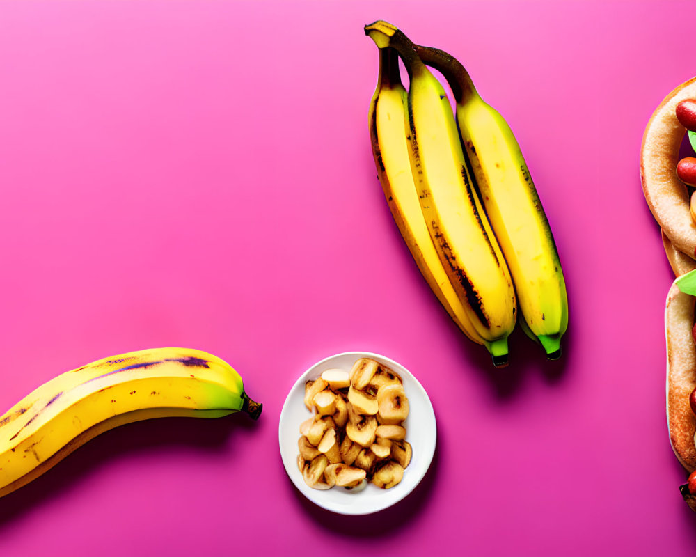 Assorted fruits and hot dogs on pink background