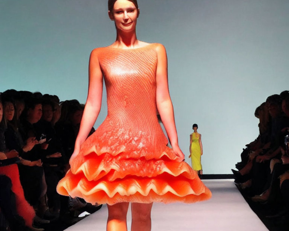 Fashion show: Model in orange textured dress with flared skirt