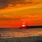 Fiery orange and red sunset over city hills