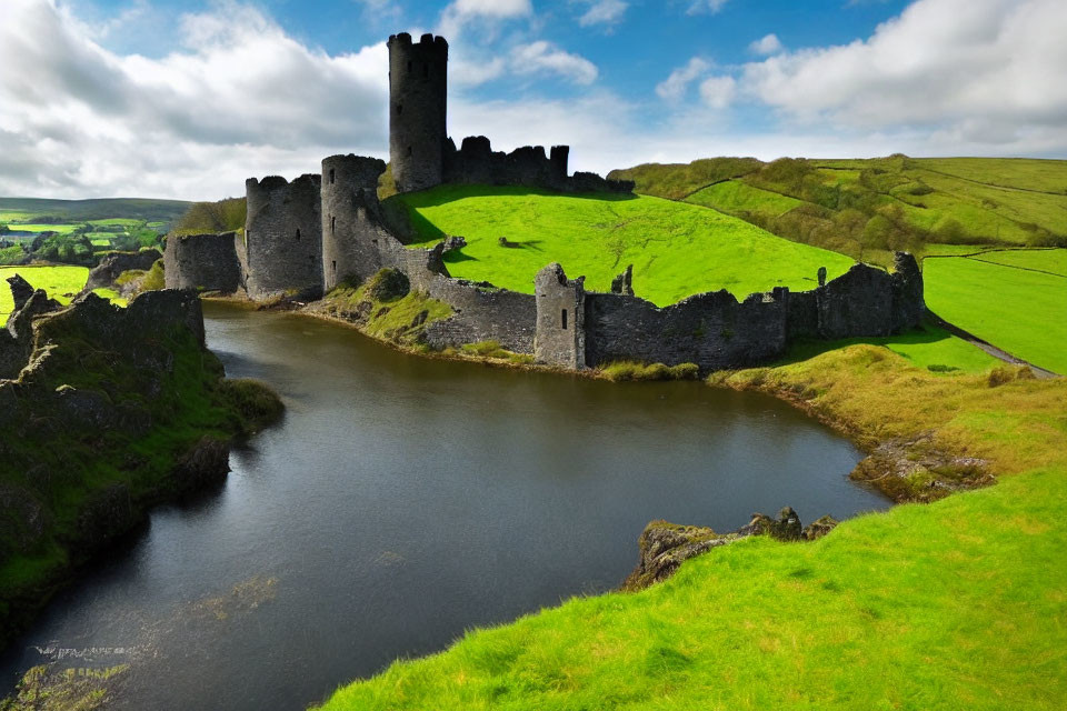 Medieval castle ruins with tower by calm river amidst green hills