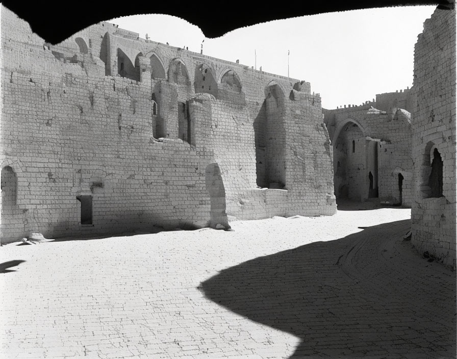 Well-preserved ancient fortress ruins with intact walls and archways in sunlight