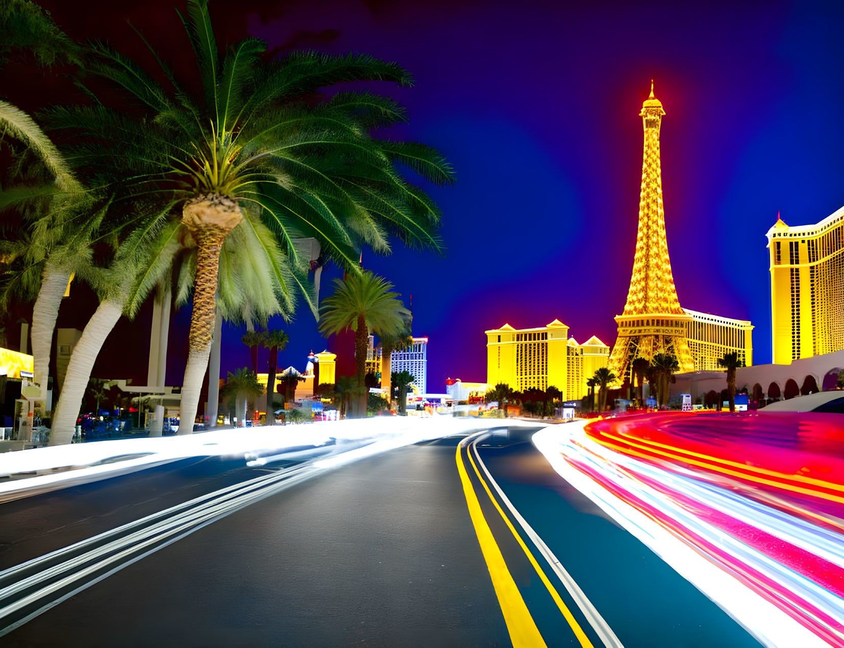 Vibrant Las Vegas night scene with Eiffel Tower replica and traffic lights