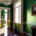 Green walls, white trim, wooden floors: Elegant interior room with crystal chandelier and wall paintings