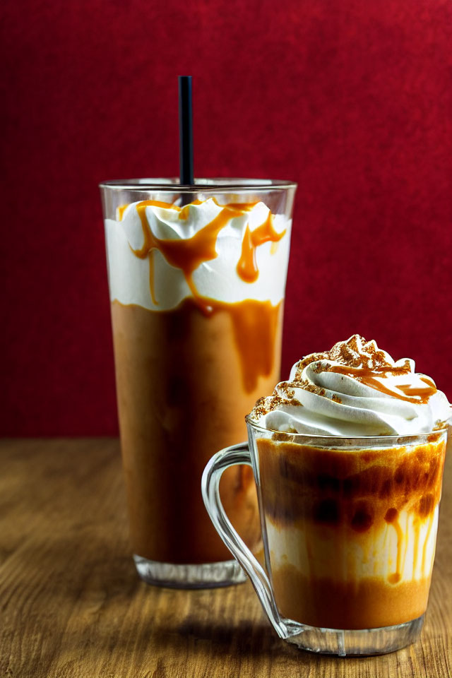 Caramel-drizzled iced coffees with whipped cream on red background