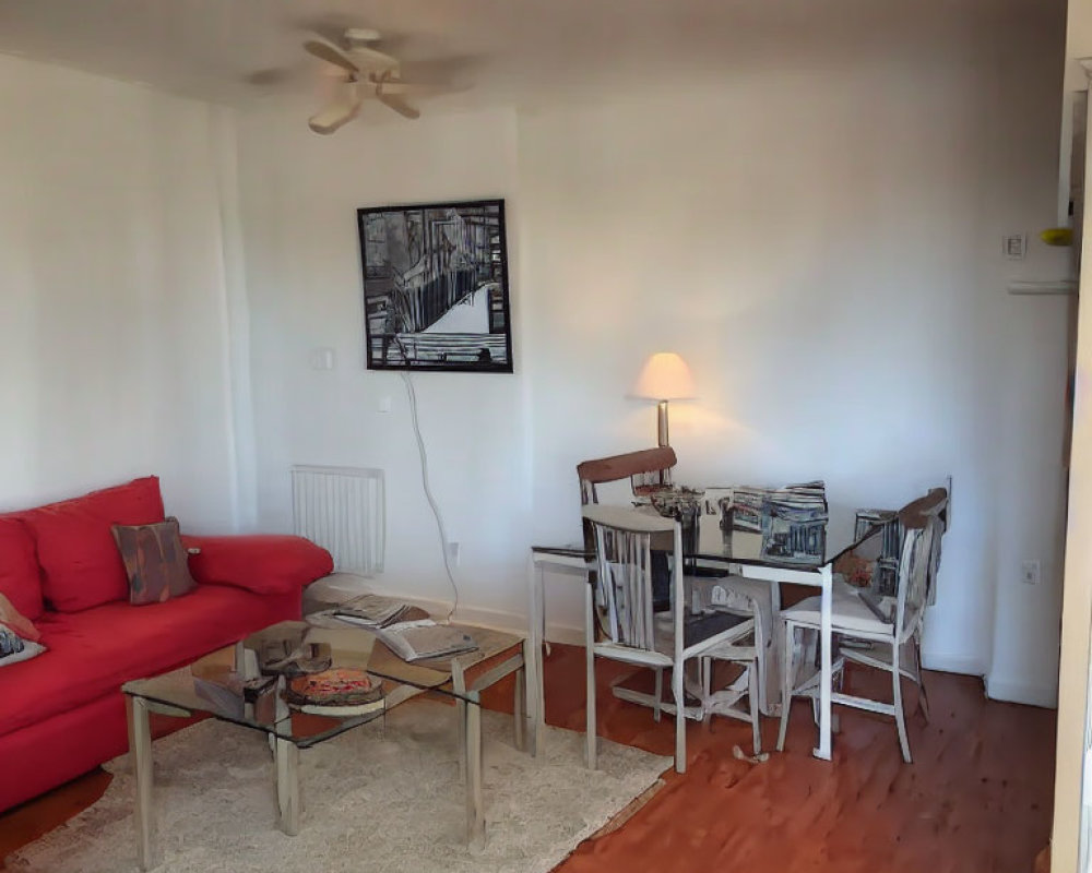 Red sofa, glass coffee table, white dining set, rug, wall art in a cozy living room