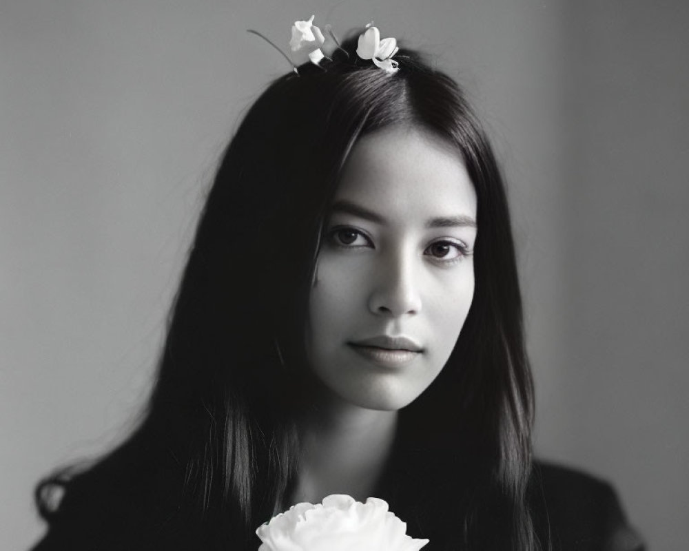 Monochrome portrait of young woman with floral hair accessory