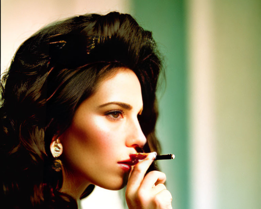 Dark-haired woman smoking cigarette with pensive expression