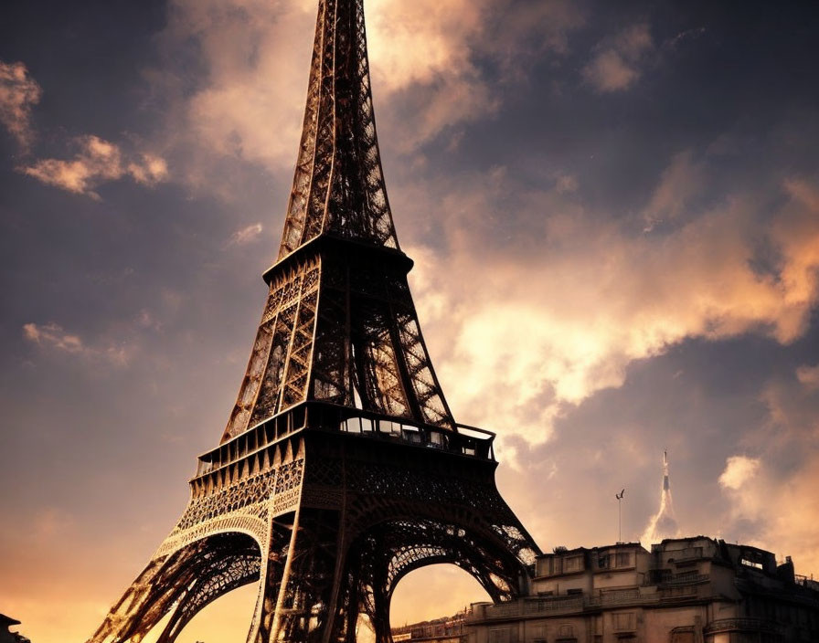 Iconic Eiffel Tower silhouette against warm sunset sky