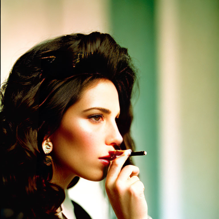 Dark-haired woman smoking cigarette with pensive expression