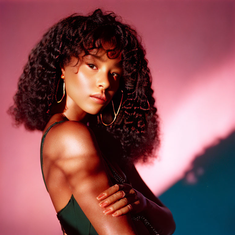 Voluminous Curly Hair Woman Poses with Pink and Blue Lighting