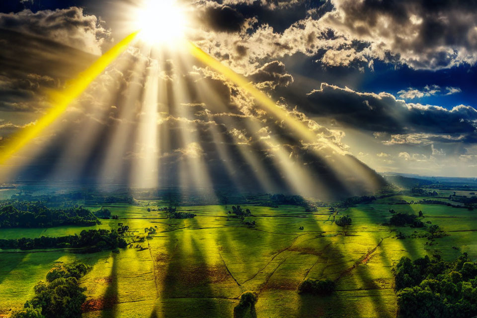 Sunbeams Through Clouds Illuminate Green Landscape