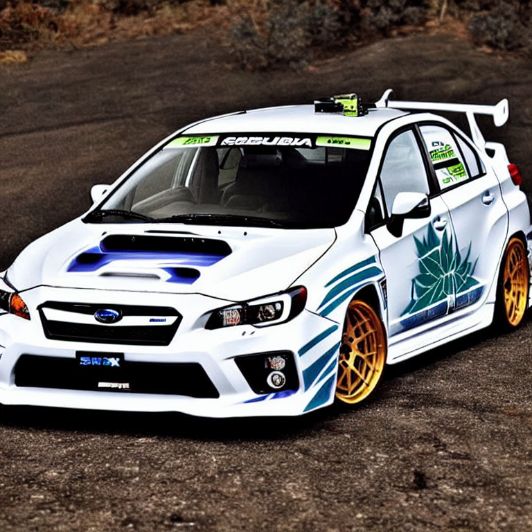 Custom White Subaru WRX with Blue Graphics, Aftermarket Wheels, and Rear Spoiler on Asphalt Road