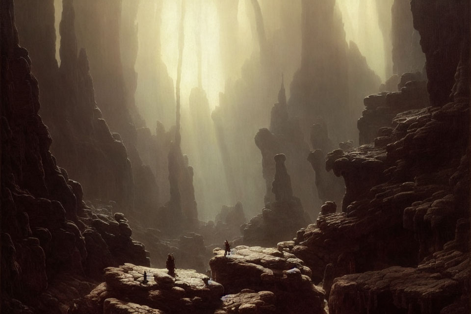 Misty cavernous landscape with towering rock formations and silhouetted figures