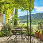 Rustic outdoor table set with cheese and bread overlooking countryside