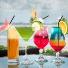 Vibrant fruit garnished cocktails by the sea