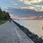 Serene lake landscape with cobblestone path and mountains