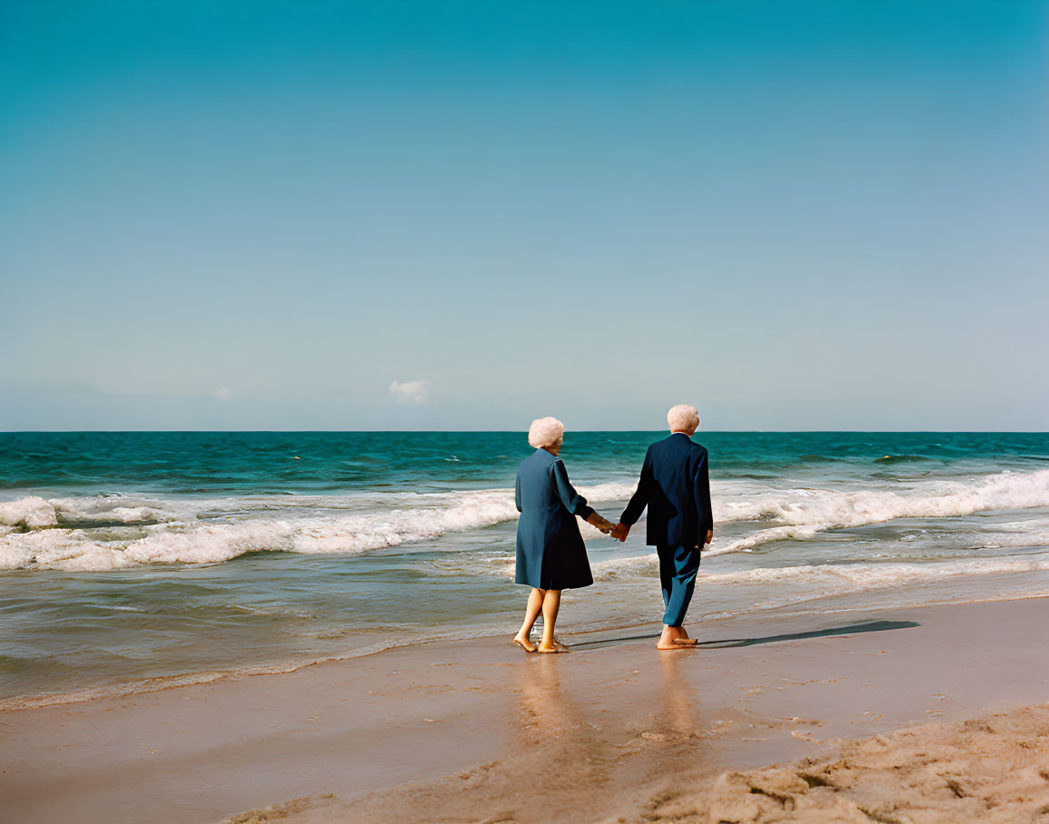 Elderly Couple Walking on Beach Facing Ocean