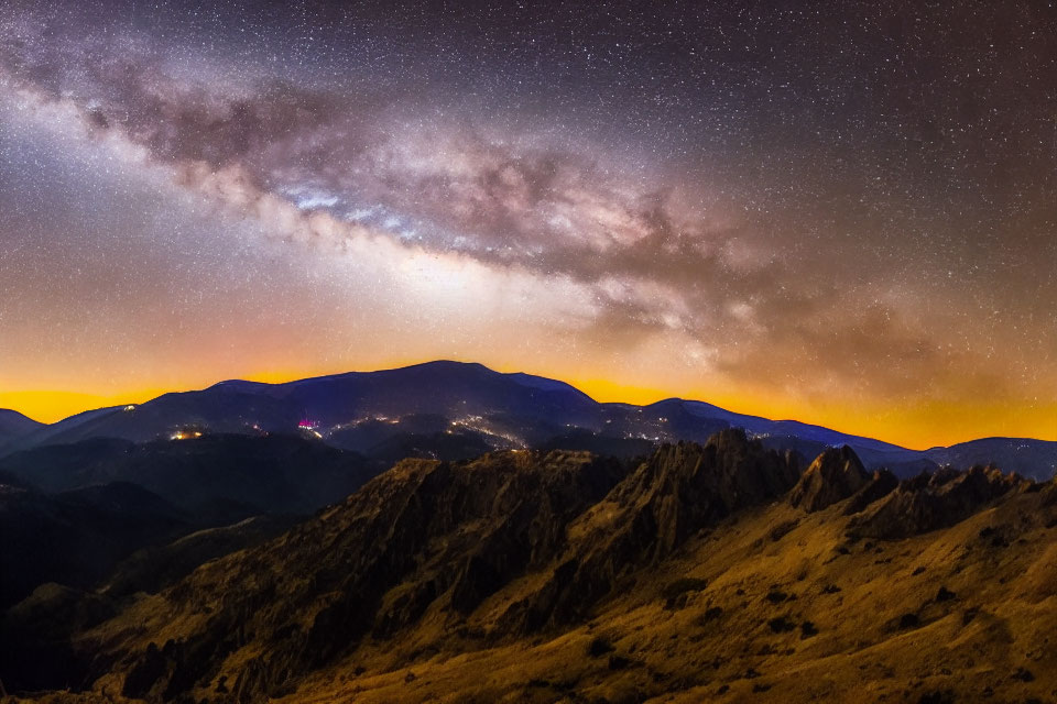 Starry Night Sky with Milky Way over Illuminated Mountain Ranges