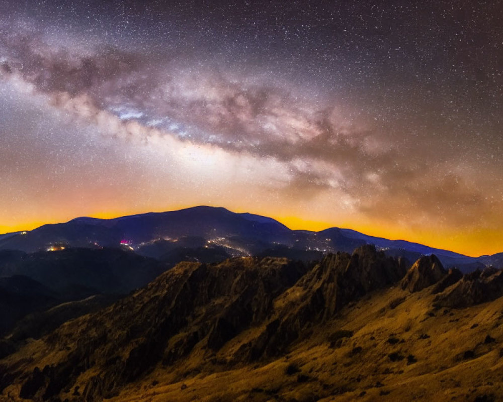 Starry Night Sky with Milky Way over Illuminated Mountain Ranges