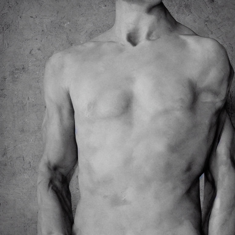 Muscular torso of shirtless person against textured background