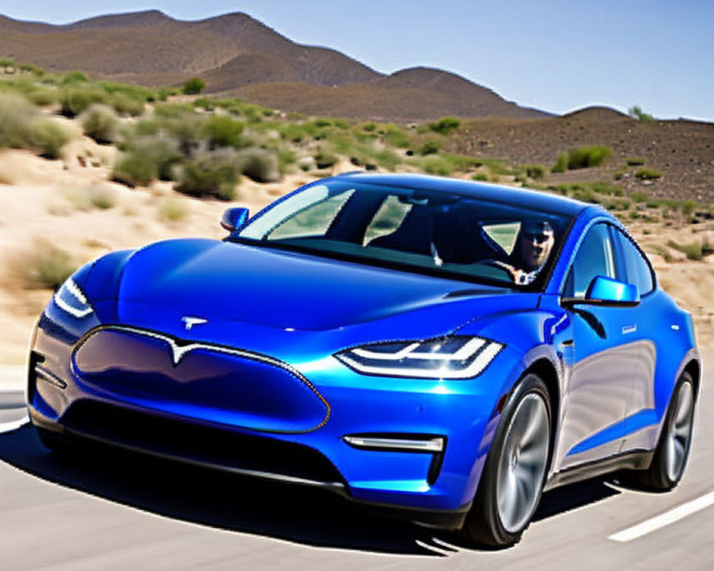 Blue electric sedan on highway with desert landscape.