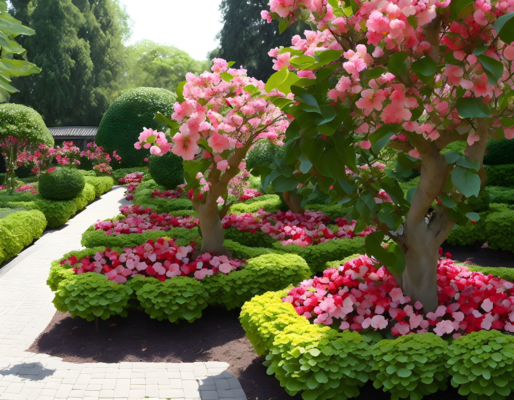 Colorful garden path with pink flowers and green shrubs under sunny sky