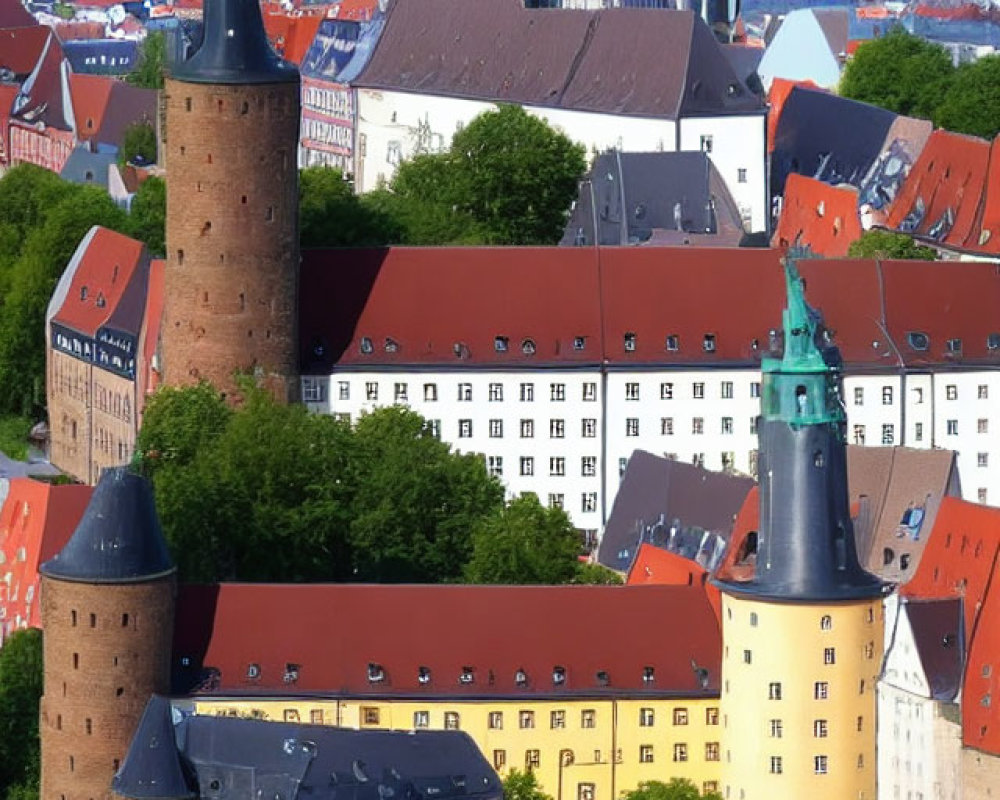 Historic cityscape with red-roofed buildings and church spires in aerial view