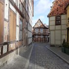 Traditional Half-Timbered Houses on Cobblestone Street with Stone Fountain