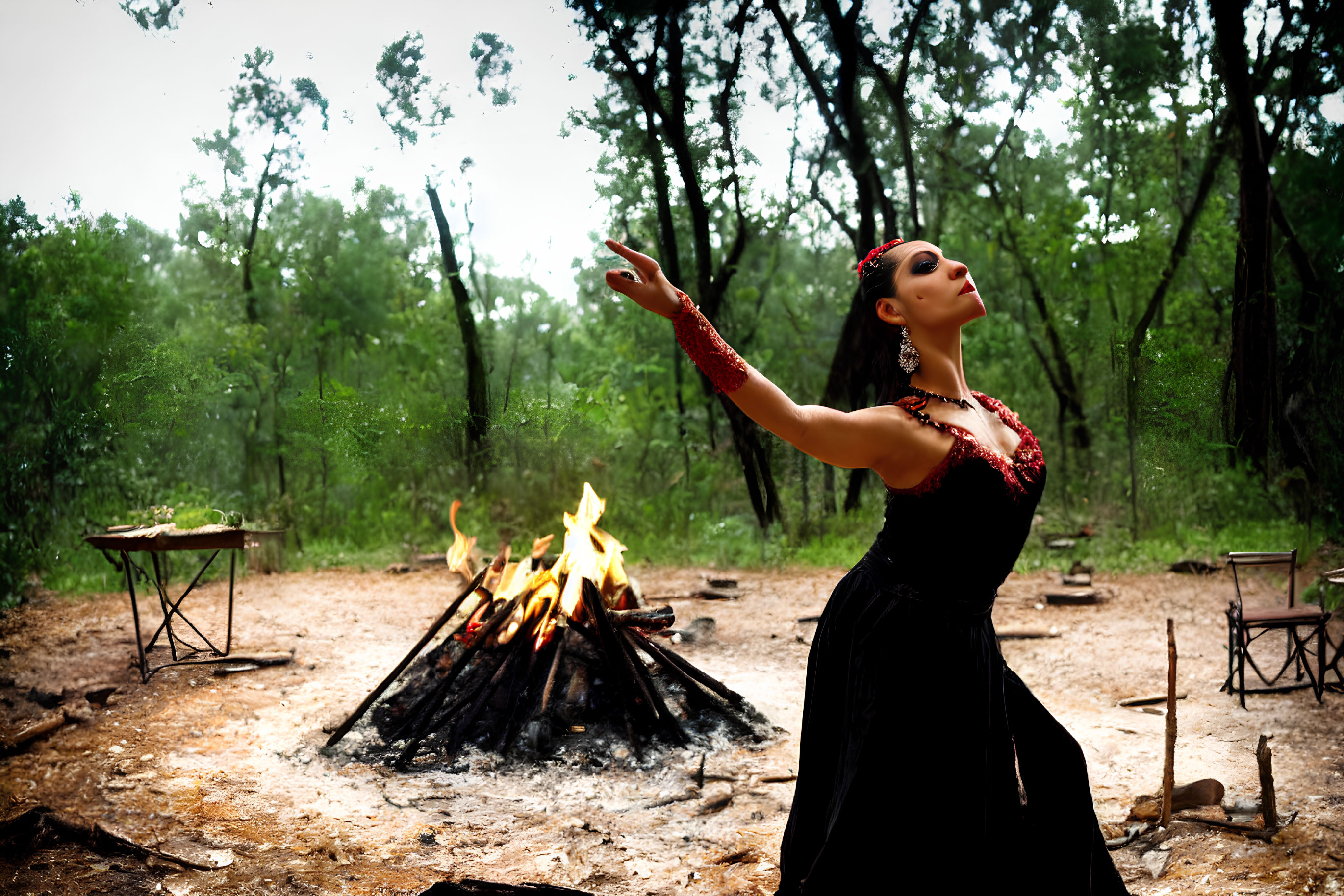 Woman in Black Dress by Campfire Reaching for Raindrops